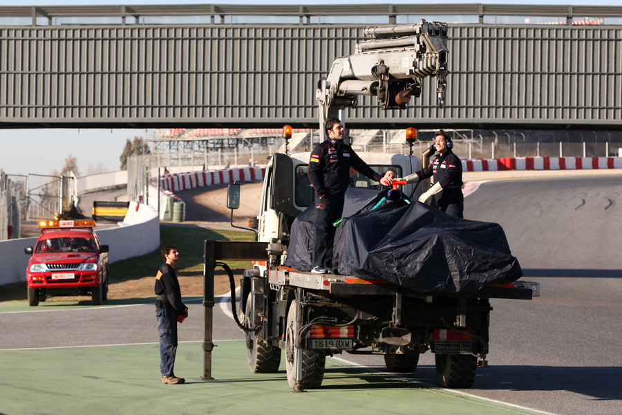 The stricken Toro Rosso is recovered on the back of a truck