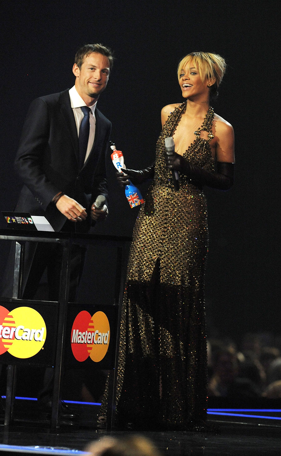 Jenson Button presents Rihanna with an award at the Brit Awards