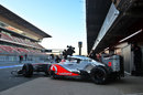 Jenson Button leaves the McLaren garage on hard tyres