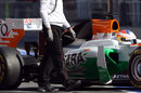 Paul di Resta returns to the pits with part of his engine cover missing, which caused a red flag
