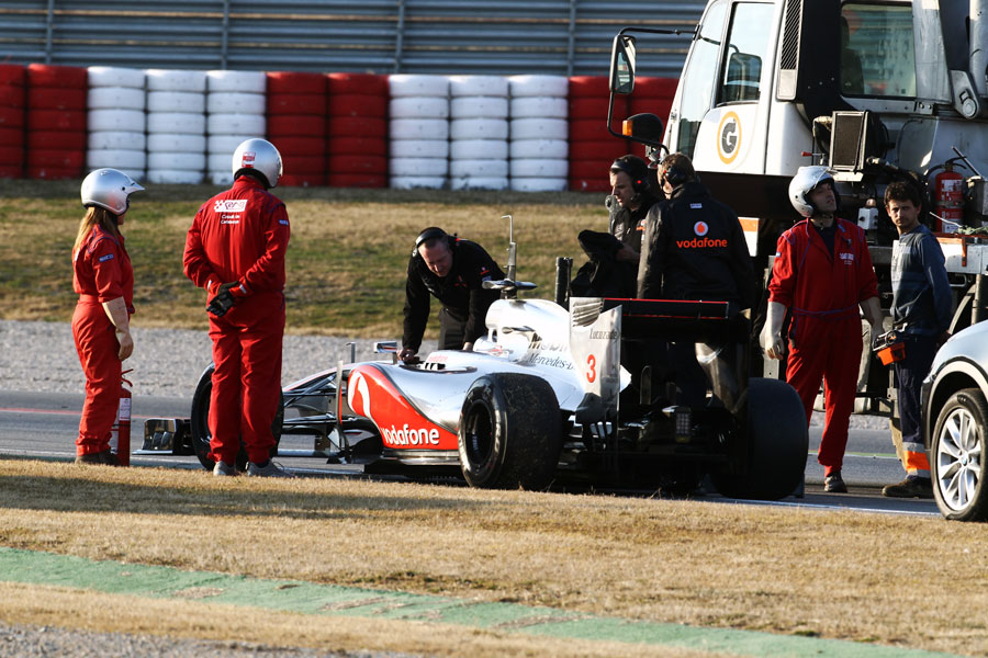 McLaren mechanics arrive at Jenson Button's stricken MP4-27