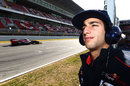 Daniel Ricciardo keeps an eye on the progress of team-mate Jean-Eric Vergne