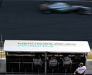 Nico Rosberg flashes past the Mercedes pits on Friday