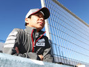Kamui Kobayashi watches on from the pit wall