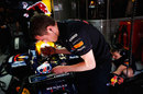 A mechanic works on Mark Webber's Red Bull