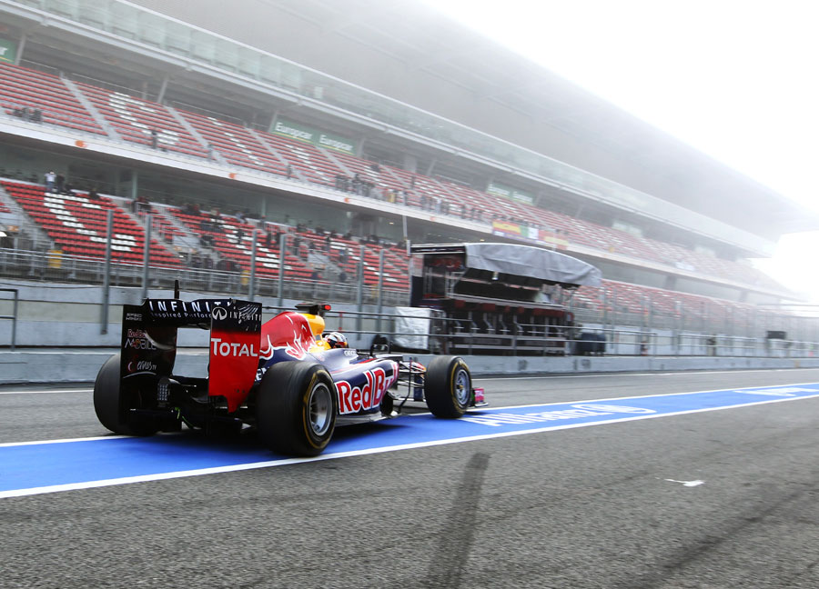 Sebastian Vettel leaves the pits in the early-morning mist