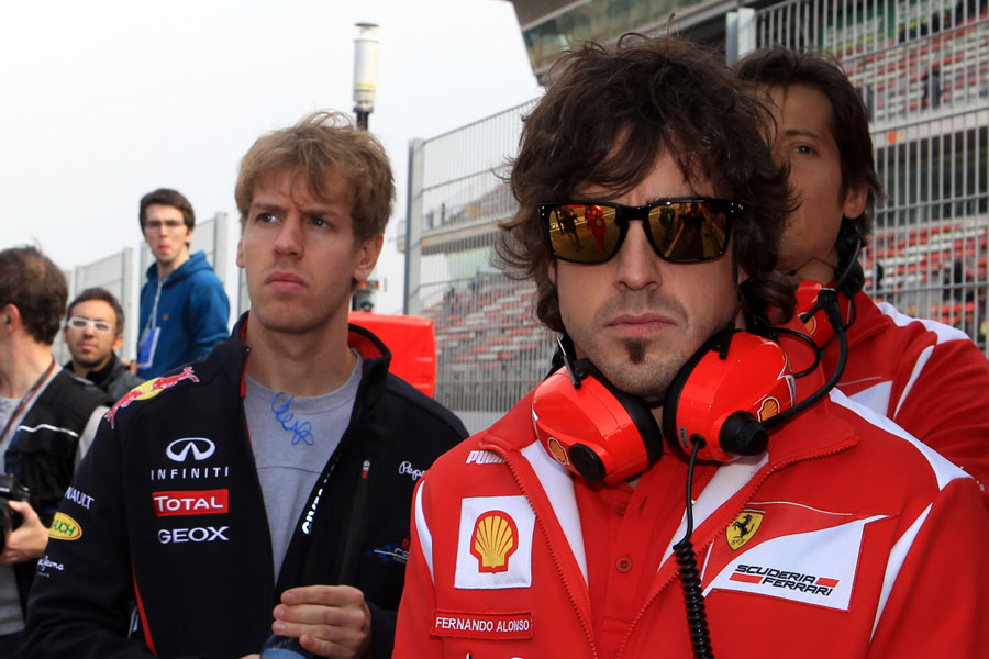 Sebastian Vettel and Fernando Alonso on the pit wall