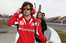 Fernando Alonso watches the action trackside