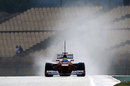 Felipe Massa's Ferrari leaves a trail of spray in its wake