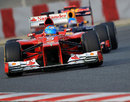 Fernando Alonso's Ferrari leads Sebastian Vettel's Red Bull