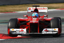 Fernando Alonso hops his Ferrari over the kerbs at the chicane