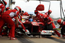 Ferrari service Fernando Alonso's car in the pits