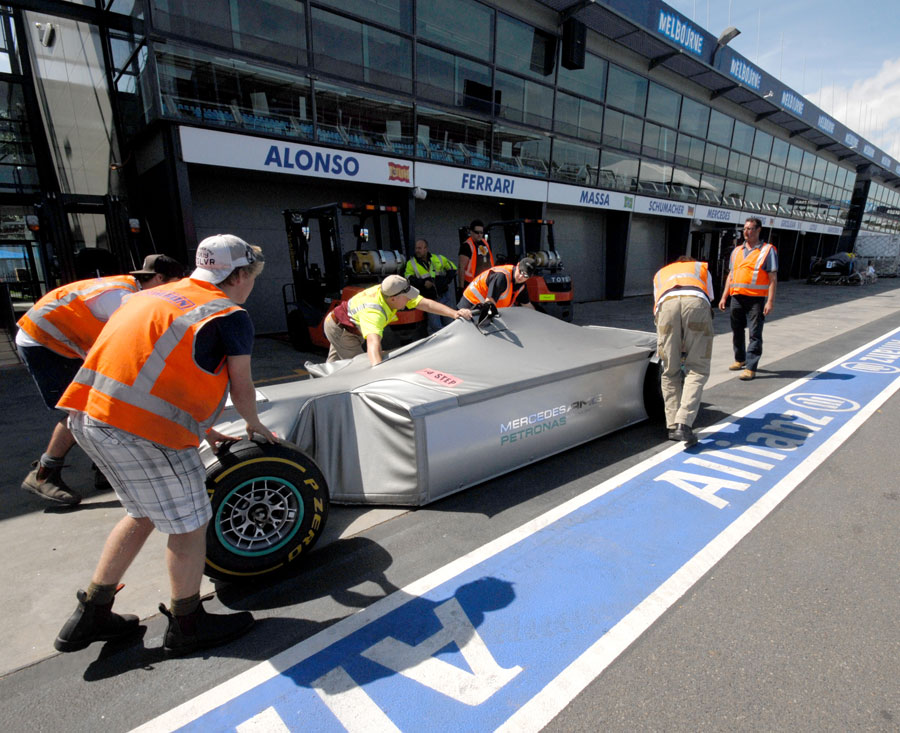 A Mercedes chassis arrives in the pit lane