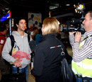 Daniel Ricciardo gets interviewed on his arrival at the airport