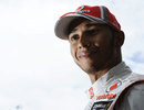 Lewis Hamilton poses for photos in the paddock