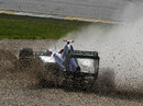 Michael Schumacher splashes through the gravel trap after spinning off at turn nine