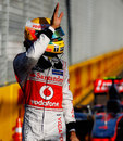 Lewis Hamilton waves to the crowd after taking pole position