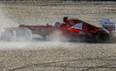 Fernando Alonso comes to rest in the gravel after spinning off at turn one