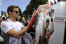 Jenson Button signs autographs when he arrives at Albert Park on Sunday