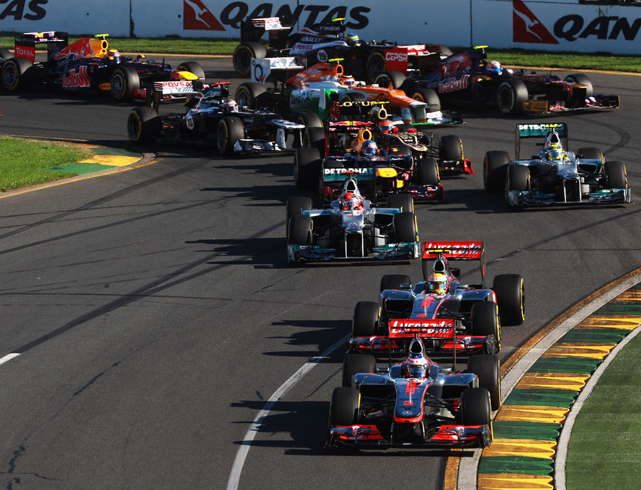 Jenson Button leads the field through the first corners at the start of the race
