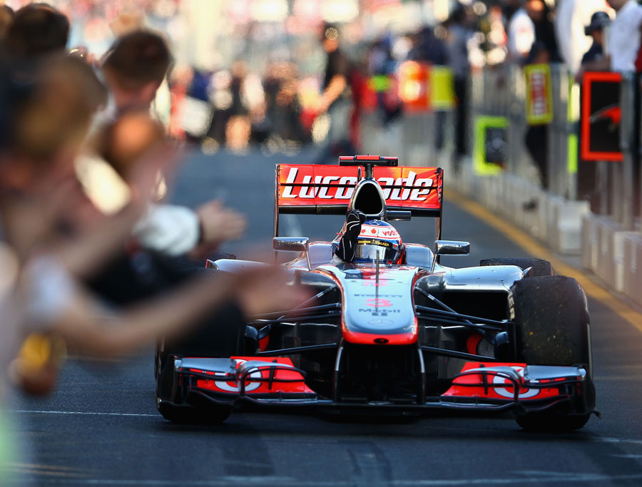 Jenson Button returns to the pit lane after winning the race