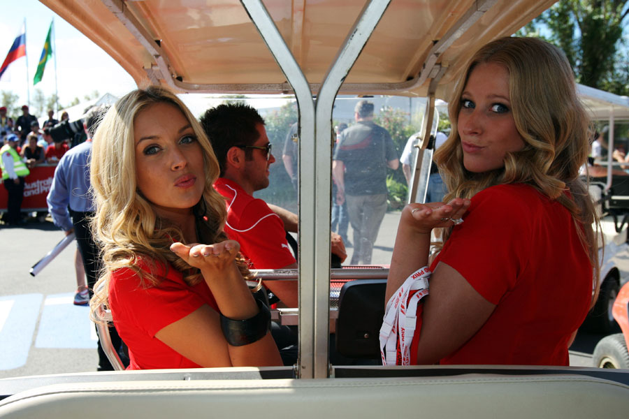 Grid girls catch a lift to the paddock
