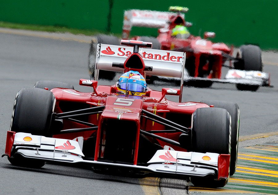 Fernando Alonso leads Felipe Massa on track