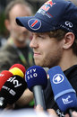 Sebastian Vettel speaks to the media in the paddock
