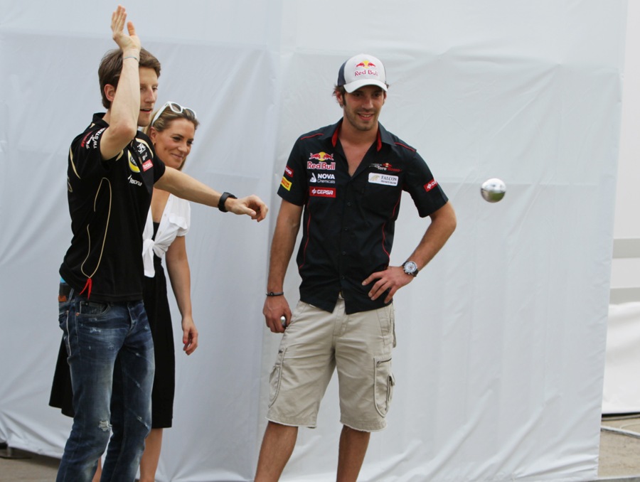 French drivers Romain Grosjean and Jean-Eric Vergne play boules in the paddock