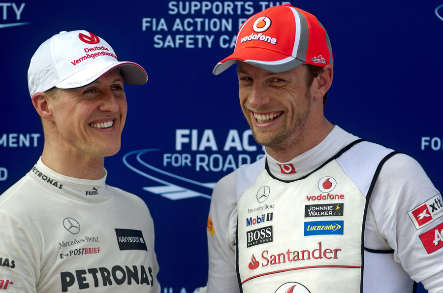 Jenson Button and Michael Schumacher joke in parc ferme