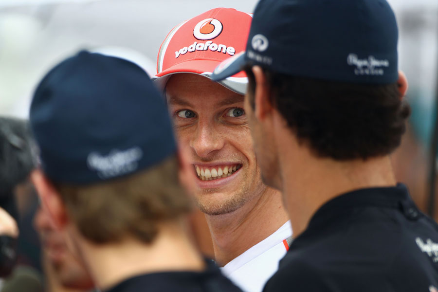 Jenson Button shares a joke with the Red Bull drivers