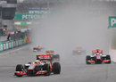 Lewis Hamilton leads Jenson Button as the rain intensifies