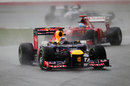 Sebastian Vettel comes under pressure from Fernando Alonso as the rain increases