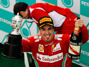 Fernando Alonso celebrates his first victory of the season on the podium at the Malaysian Grand Prix