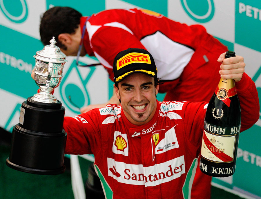 Fernando Alonso celebrates his first victory of the season on the podium