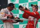 Lewis Hamilton celebrates with Fernando Alonso on the podium