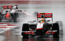 Lewis Hamilton leads Jenson Button during the worst of the conditions