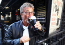 Eddie Jordan celebrates his honorary OBE with a drink at the Toucan Bar