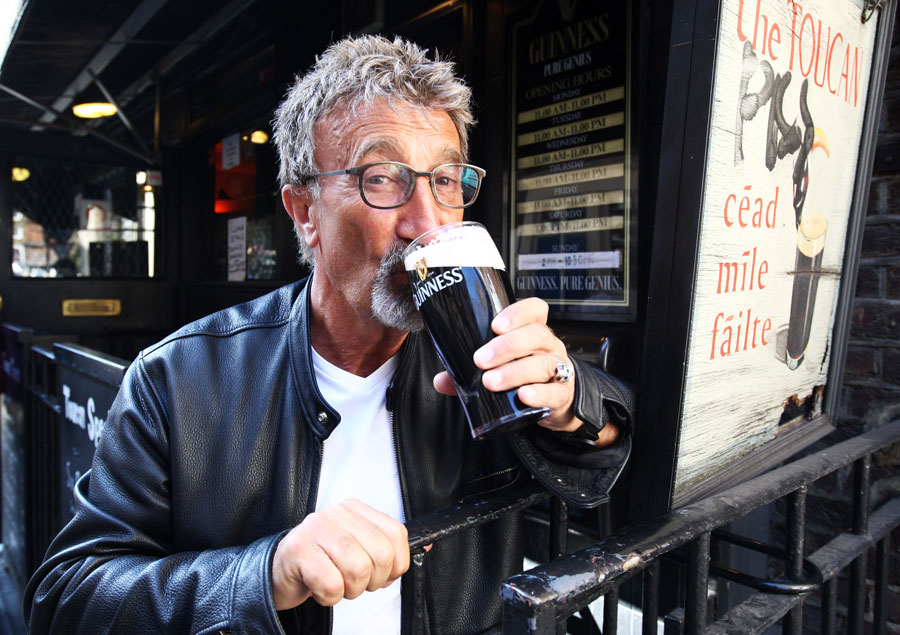 Eddie Jordan celebrates his honorary OBE with a drink at the Toucan Bar