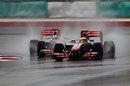 Lewis Hamilton leads Jenson Button during the worst of the conditions