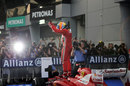 Fernando Alonso celebrates his first victory of the season on top of his car