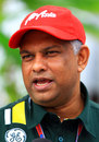 Tony Fernandes speaks to the press in the paddock on Saturday