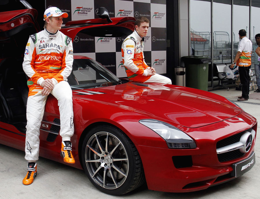 Force India drivers Nico Hulkenberg and Paul di Resta pose with a Mercedes SLS