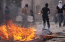 Bahraini anti-government protesters face off against riot police  
