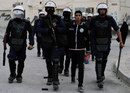 Police arrest a protester in Bahrain as anti-government unrest continued in the build-up to the grand prix