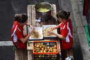 Ferrari catering staff peel potatoes in the paddock