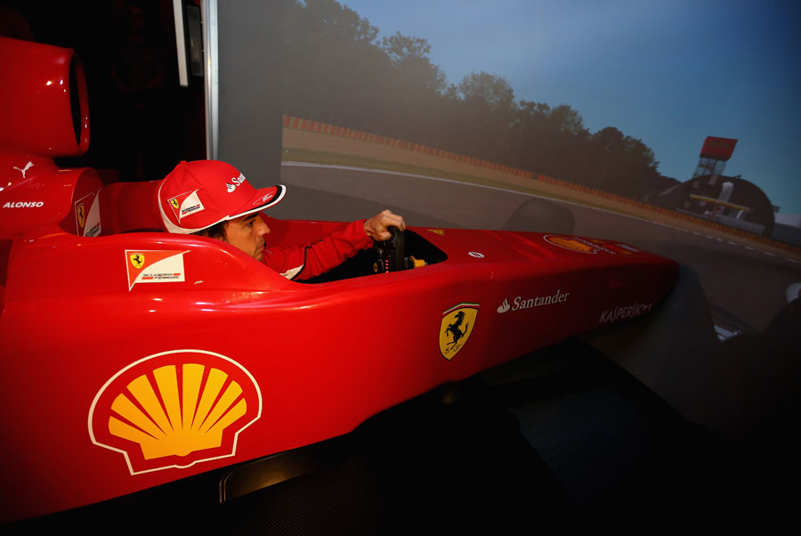 Fernando Alonso drives a Ferrari simulator during a press commtiment at Shell