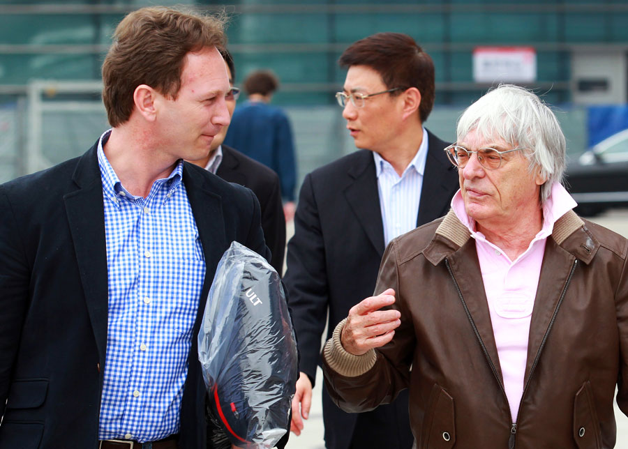 Bernie Ecclestone speaks to Christian Horner in the paddock