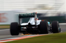 Sparks fly from the rear of Michael Schumacher's Mercedes