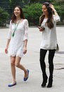 Jessica Michibata and her younger sister Angelica walk through the Shanghai paddock